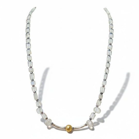 Sinnikäs necklace with faceted moonstone beads, silicon beads, and a gold-plated sphere on a silver chain.