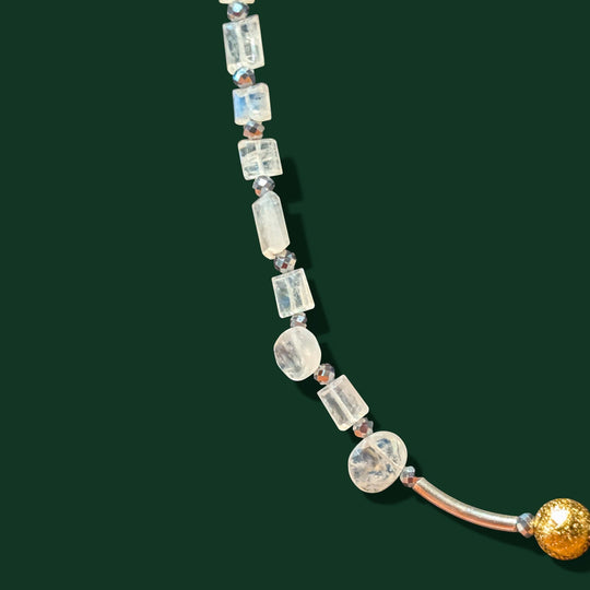 Sinnikäs necklace with faceted moonstone, silicon beads, and a gold-plated ball accent.